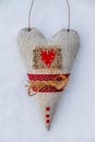 Valentine's Day Wallpaper. Soft toy heart lies on the snow. Valentine's day.