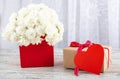 Bouquet of white roses in a red box and a symbol of the heart for the inscription. Royalty Free Stock Photo