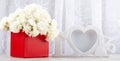 White roses in a red square box and a white photo frame close-up Royalty Free Stock Photo