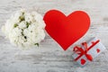 A bouquet of white roses, a box with a gift and a red heart for inscription. Royalty Free Stock Photo