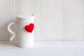 Valentine`s Day with white cup coffee red heart on the cup, wood white background. Royalty Free Stock Photo