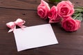 Valentine`s Day: White empty paper card and roses petals Royalty Free Stock Photo