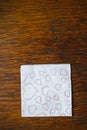 Valentine`s Day. White napkin with heart prints lies on a wooden table