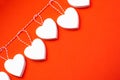 Valentine`s Day. White wooden hearts on a red background. Blank for the designer. Valentines day concept. Greeting card