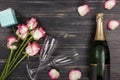 Valentine`s Day, Women`s day, champagne, bouquet, scarlet roses, black, wooden background, Mother`s day, wedding day, birthday.