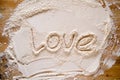 Valentine's Day. The word LOVE is written in flour, on a wood texture. Copy space. Conceptual. Royalty Free Stock Photo