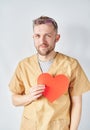 Valentine's Day: young male doctor or nurse in uniform Royalty Free Stock Photo