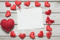 Valentine`s greeting card. Red hearts and gift with space for text on white wooden board. Top view Royalty Free Stock Photo