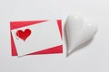 Valentine day mock up with blank message card and white porcelein heart
