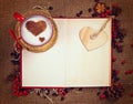 Valentine`s postcard. Cup of coffee on open book with wooden heart on it. Royalty Free Stock Photo