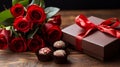 Valentine\'s scene with a bouquet of red roses and a box of chocolates. Royalty Free Stock Photo