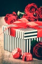 Valentine's setting with red roses and retro gift box