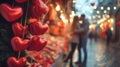 Valentine stand in the street full of red hearts with young couple in embrace. Royalty Free Stock Photo