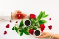 Valentine still life with pearl ring in man hand, red roses and woman hand with coffee