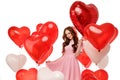 Valentine& x27;s day. Beauty girl holding red air balloons, symbols of love. Happy Young woman laughing. Model having fun Royalty Free Stock Photo