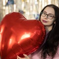 Valentine& x27;s Day. Beauty joyful teenage girl with red heart shaped air balloons having fun Royalty Free Stock Photo