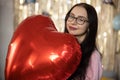 Valentine& x27;s Day. Beauty joyful teenage girl with red heart shaped air balloons having fun Royalty Free Stock Photo