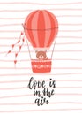 A Valentine's day card with a cute bear flying in a balloon and a handwritten phrase - Love is in the air. A symbol Royalty Free Stock Photo