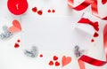 Frame made of gifts, candle, red hearts, ribbon on white background. Valentines day background.
