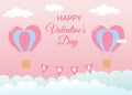 Valentine's Day greeting card. Air balloons in heart shape flying in the sky. Pink background with white and blue clouds Royalty Free Stock Photo