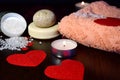Valentines day in Spa style. two red hearts and items for Spa treatments in a low key. Royalty Free Stock Photo
