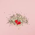 Valentines abstract Top view of golden stars confetti red heart in two pieces with copy space millennial pink color paper