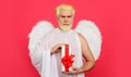 Valentines angel with gift box. Cupid with present. Serious bearded man with white wings. Valentine day presents. Royalty Free Stock Photo