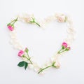 Valentines background. Heart symbol of roses petals on white background. Flat lay, Top view. Royalty Free Stock Photo