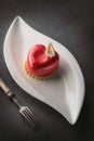Valentines cake with heart shape with metal fork on black backgrount, produkt photography for patisserie