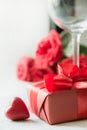 Valentines card with red gift box, roses, champagne bottle on white. Space for text Royalty Free Stock Photo