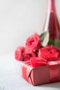 Valentines card with red gift box, roses, champagne bottle on white. Space for text Royalty Free Stock Photo