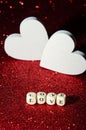 Valentines day abstract background. Selective focus letters on cubes Love on red shiny background with decorative Hearts. Shiny