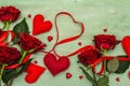 Valentines Day background with assorted hearts, fresh burgundy roses and red festive ribbon Royalty Free Stock Photo
