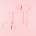 Valentines day background with blank square frame and paper hearts on gentle pink color background. Royalty Free Stock Photo