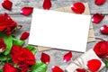 Blank white greeting card with red rose flowers bouquet and envelope with petals and gift box Royalty Free Stock Photo