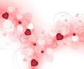 Valentines day background with blurry red hearts and spiral floral pattern.