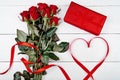 Valentines Day background with bouquet of red roses, gift box, ribbon shaped as heart, copy space. Greeting card mockup. Love Royalty Free Stock Photo