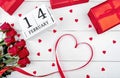 Valentines Day background with bunch of red roses, gift boxes, ribbon shaped as heart and wooden block calendar february 14 Royalty Free Stock Photo