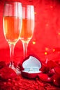 Valentines day background with champagne, ring and rose petals Royalty Free Stock Photo