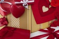 Valentines day background composition of gift boxes and red heart metal shaped packages with bows and ribbons top view on