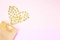 Valentines Day background concept. Golden paper gift bag And small stars in the shape of heart on pink paper background Royalty Free Stock Photo