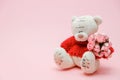 Valentines Day background. Cute teddy Bear toy with bouquet of flowers on pink background. February 14 greeting card. Royalty Free Stock Photo