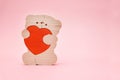 Valentines Day background. Cute teddy Bear toy with red heart on pink background. February 14 greeting card. Royalty Free Stock Photo