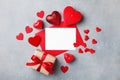 Valentines day background with gift box, empty card and red hearts