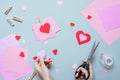 Valentines day background. Hands making Valentine card with heart and on the blue background Royalty Free Stock Photo