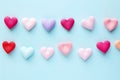 Valentines Day background with many small paper hearts in pastel colors