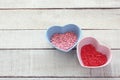 Valentines day background, many small red pink sugar hearts in bowls Royalty Free Stock Photo