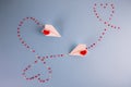 Valentines Day background. Paper planes flying with the heart shapes. Love message