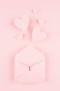 Valentines day background of pink paper envelop and stream soar small hearts on pink paper background.