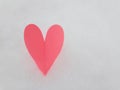 Valentines Day background. Pink paper heart on fluffy snowy background.